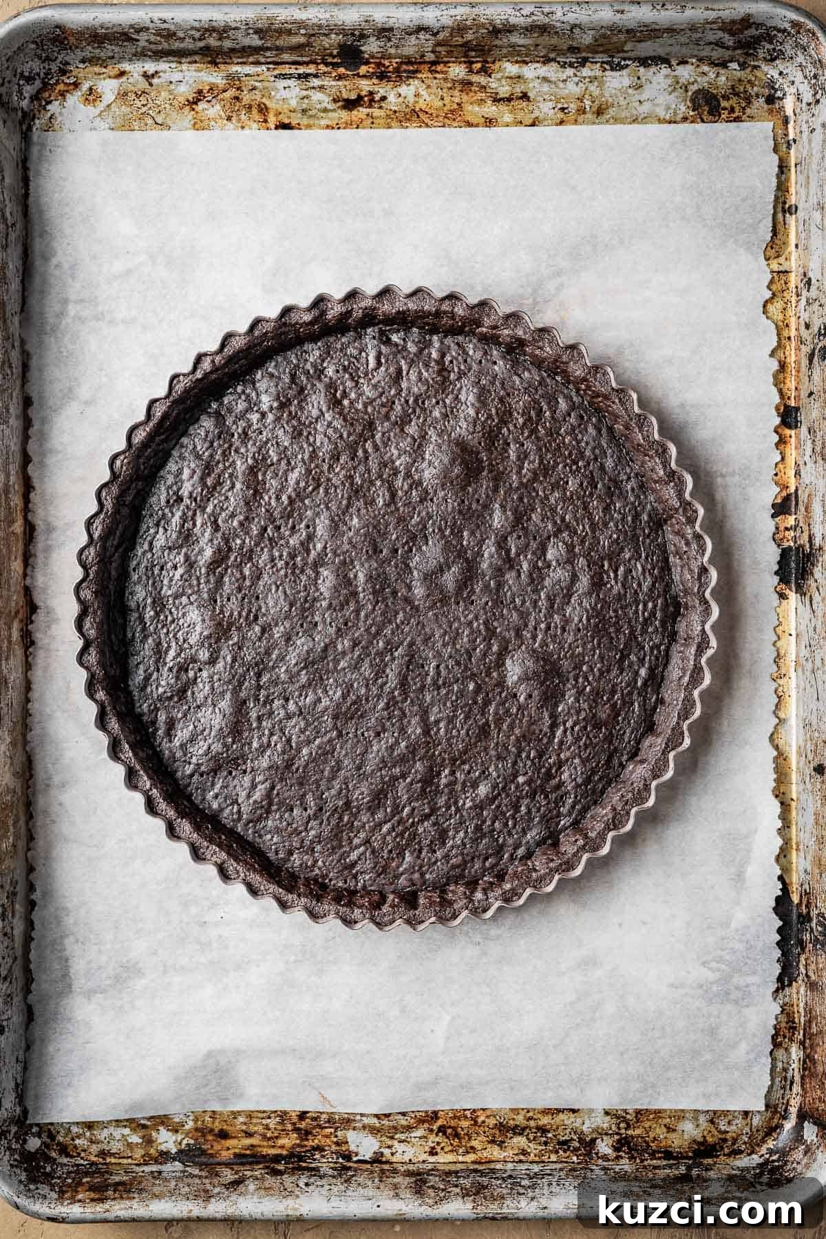 A baked and egg washed chocolate tart crust.