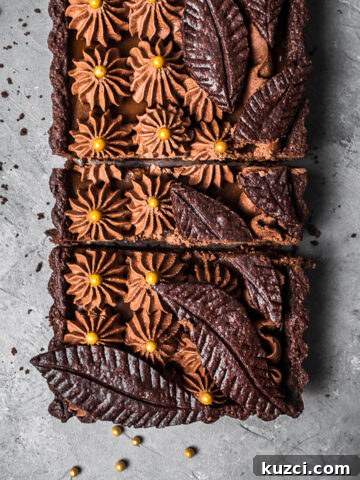 A rectangular chocolate tart with caramel and whipped chocolate ganache.