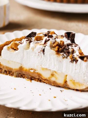 A slice of banoffee tart with dulce de leche, bananas, and whipped cream.