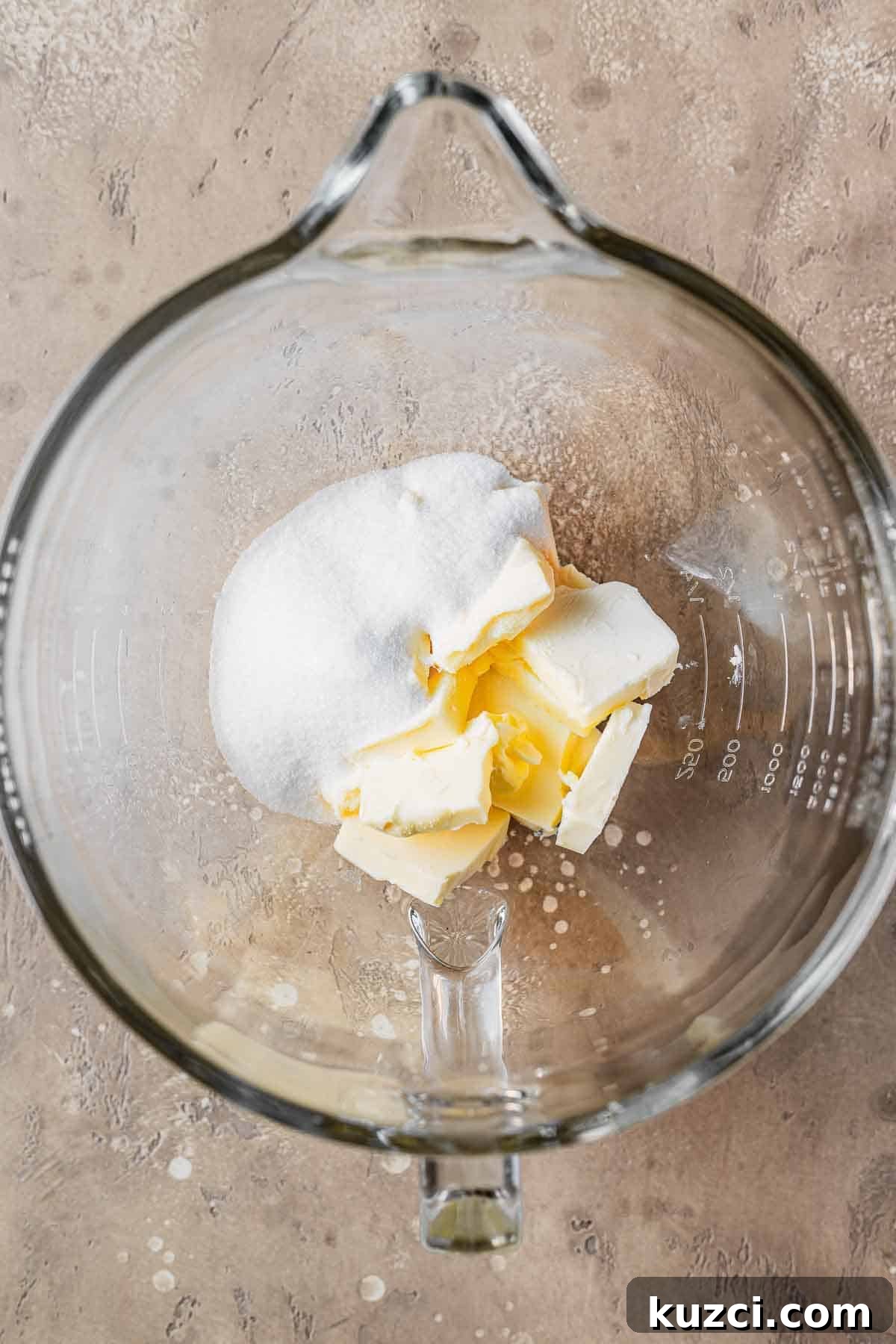 Sugar and butter in a mixing bowl.