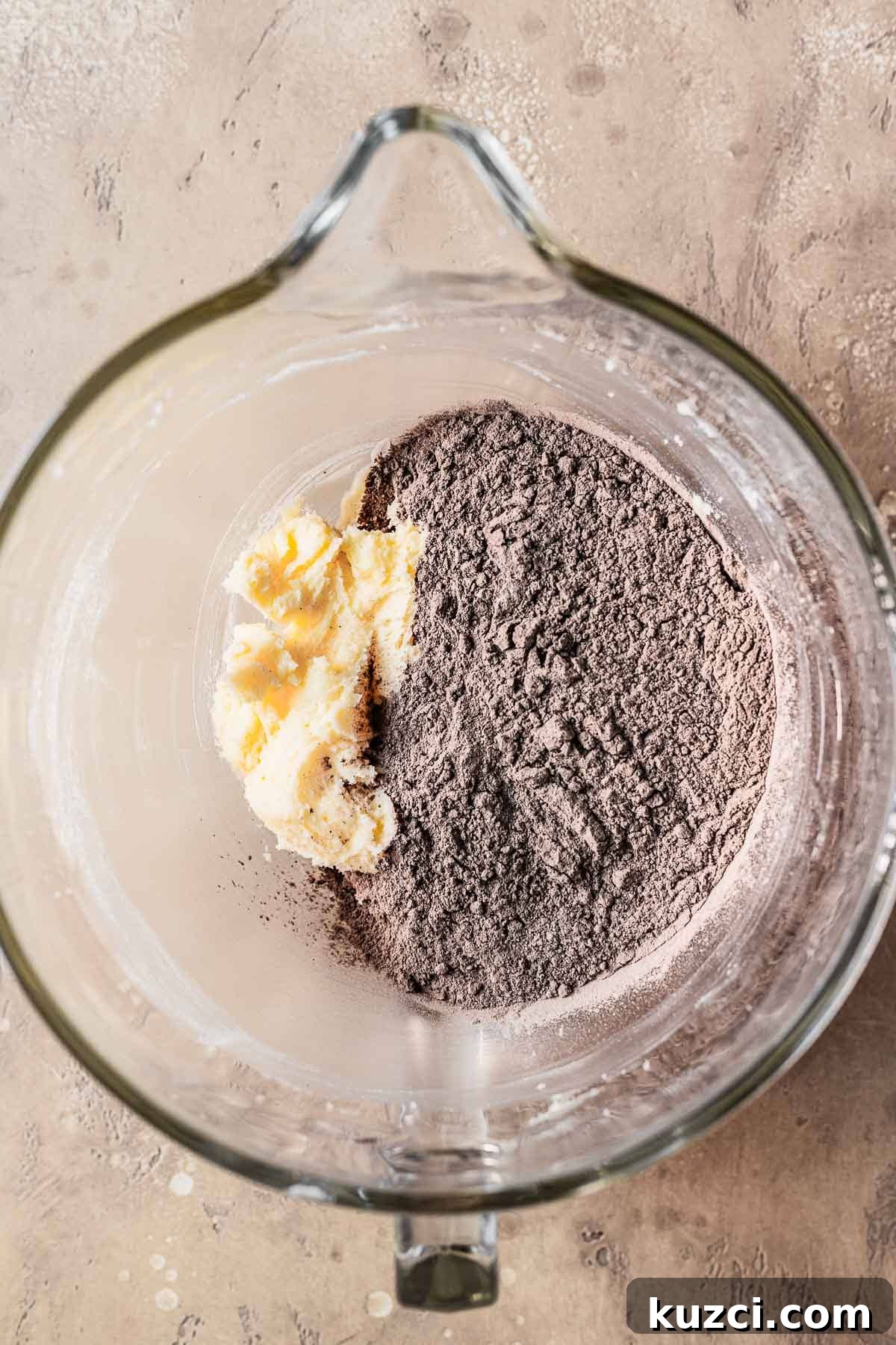 Dry ingredients with creamed butter and sugar in a mixing bowl.