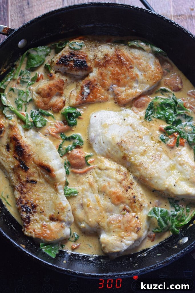 Skillet Chicken with Tomatoes and Spinach Recipe 13 Cooking chicken in a cream sauce in a skillet.