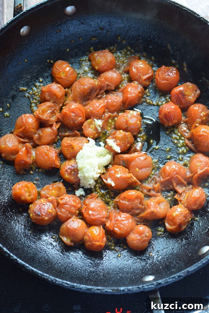 Skillet Chicken with Tomatoes and Spinach Recipe 10 Cooking tomatoes and garlic in a skillet.