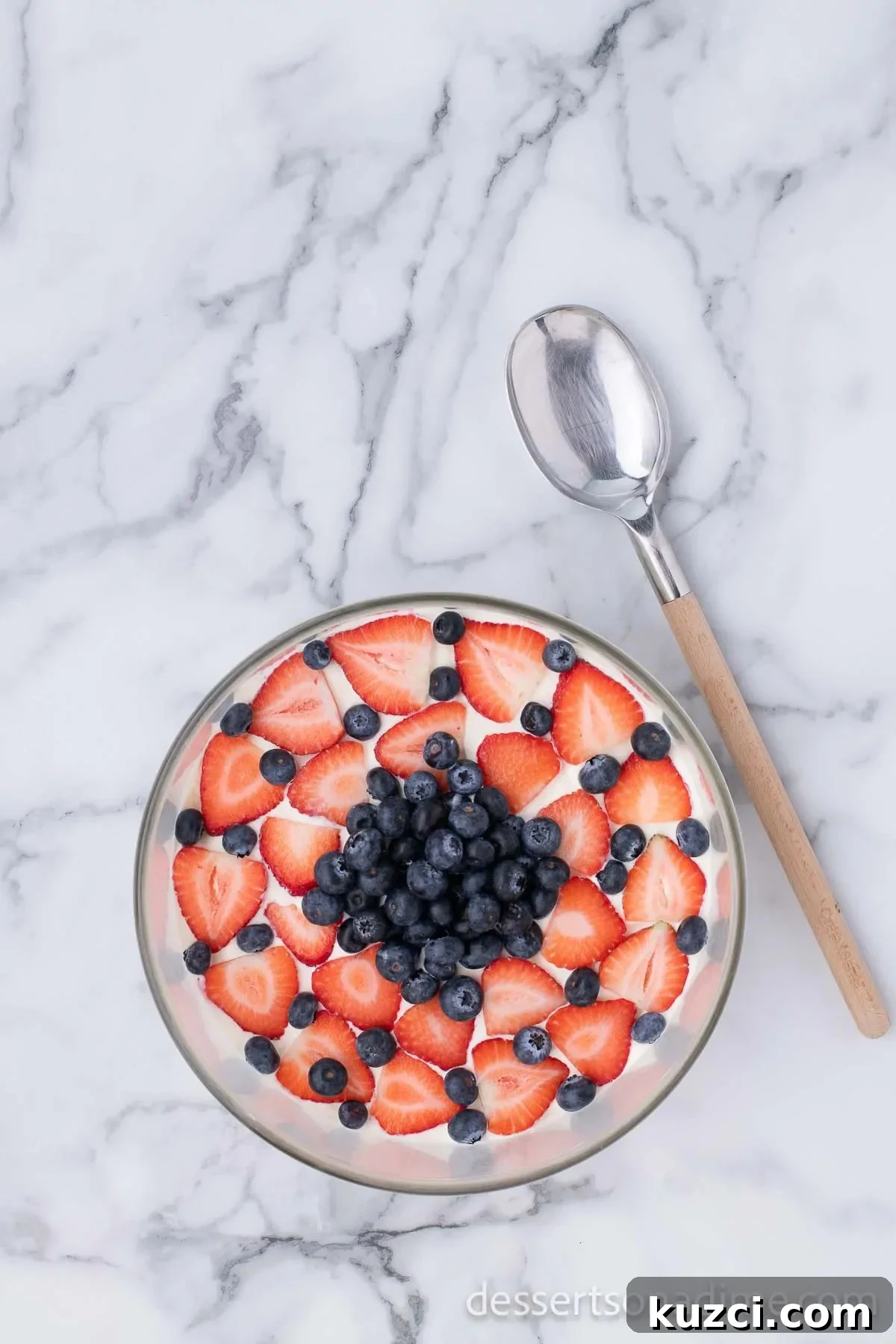 Red White and Blue Trifle Recipe for 4th of July 11 Strawberries and blueberries arranged on top of the trifle