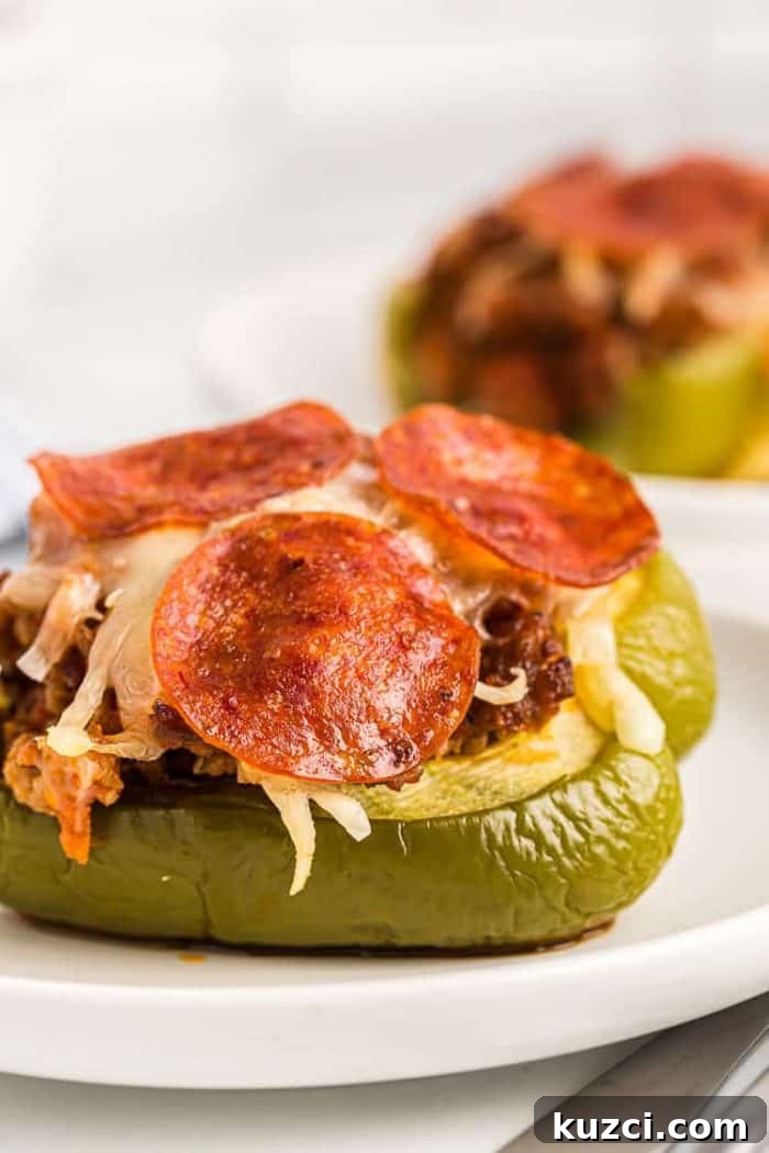 Keto Pepperoni Pizza Stuffed Peppers 13 side view of keto stuffed peppers on white plates