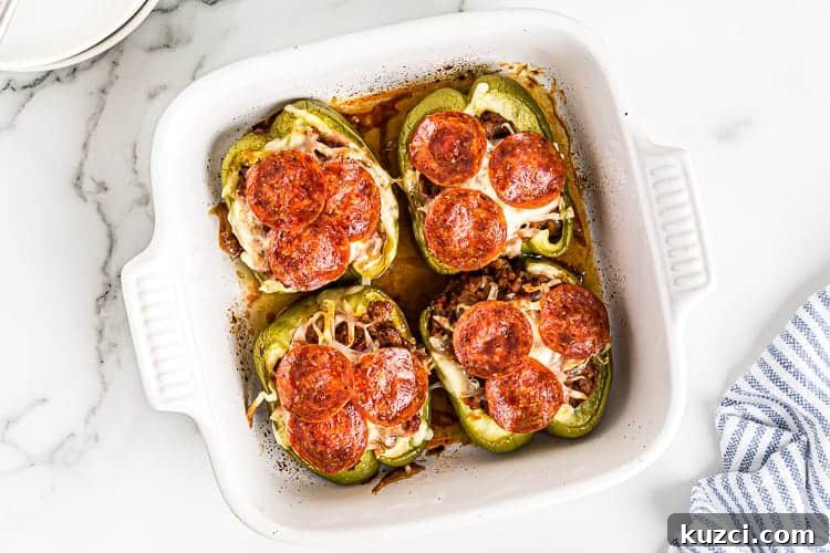 Keto Pepperoni Pizza Stuffed Peppers 5 overhead view of fully cooked stuffed peppers keto in white baking dish
