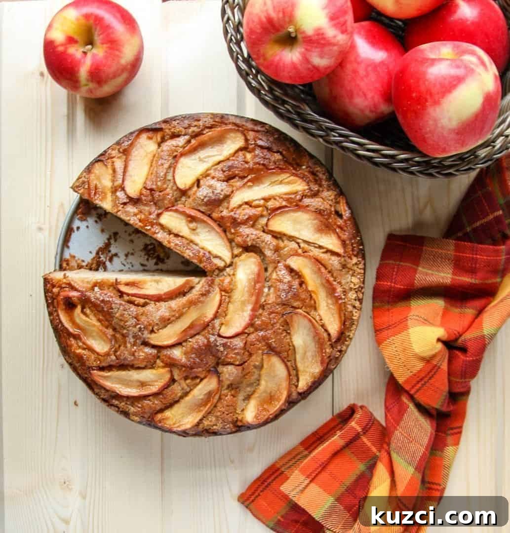 A bowl of apples sitting on a table, with a Cake 