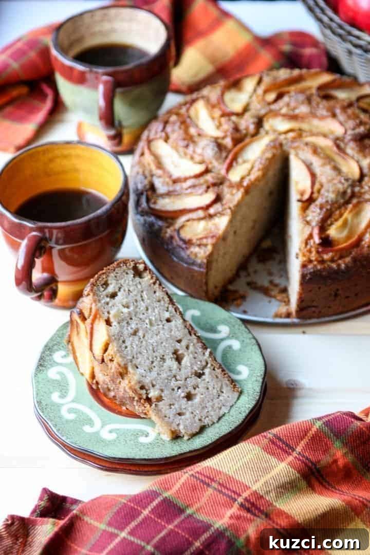 A close up of a slice of cake and a cup of coffee