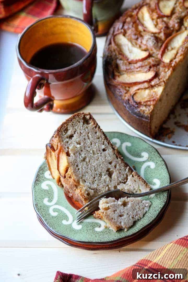 Slice of Apple Ricotta Cake on a Plate with Cup of Coffee