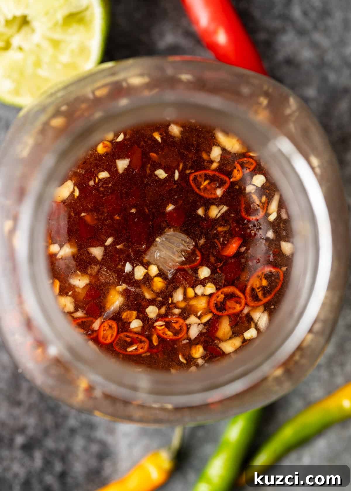 Nuoc Cham Recipe: Authentic Vietnamese Dipping Sauce 3 overhead closeup: my nuoc cham recipe in a glass jar with spices and seasonings showing