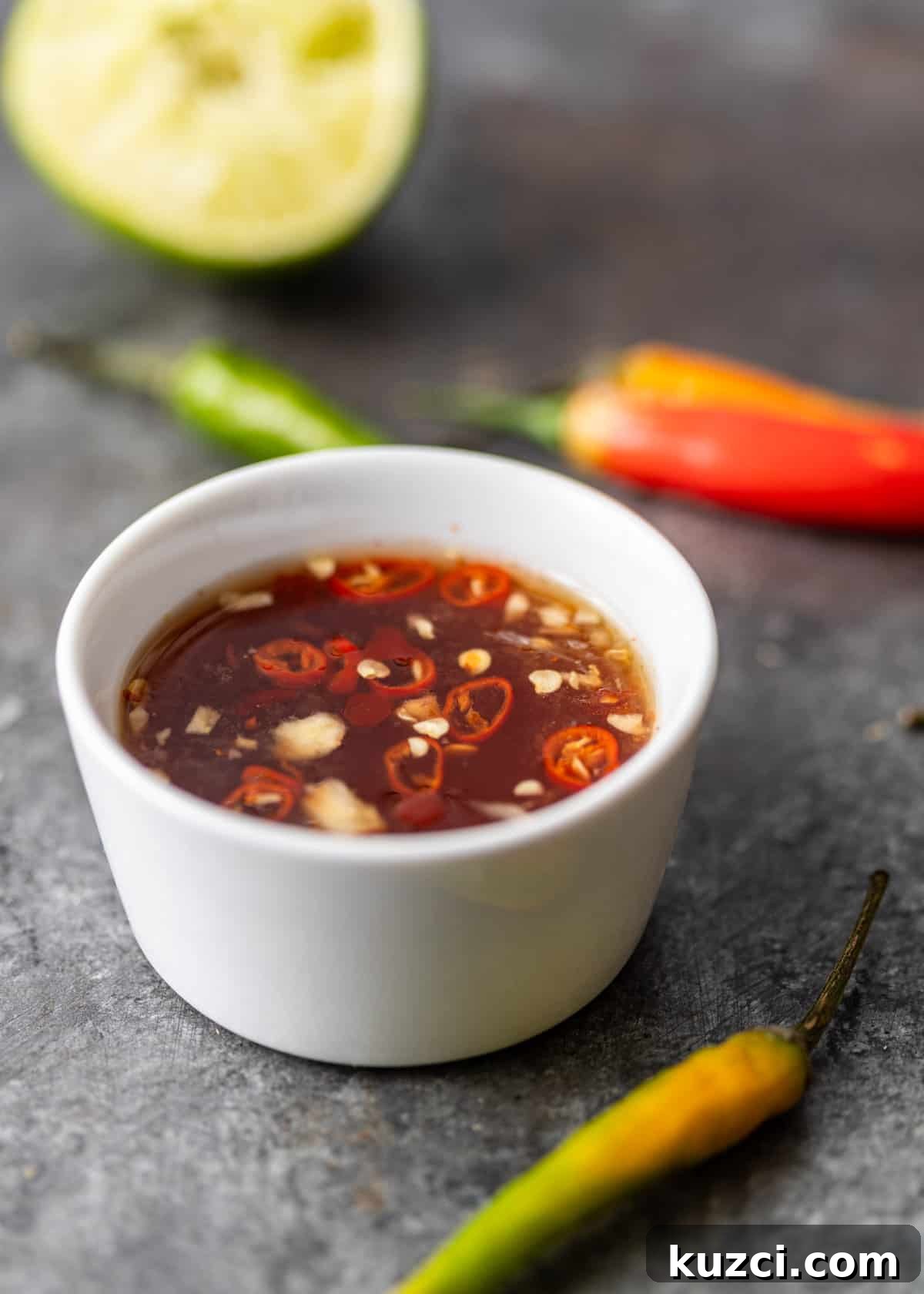 Nuoc Cham Recipe: Authentic Vietnamese Dipping Sauce 9 a small white ramekin with nuoc mam