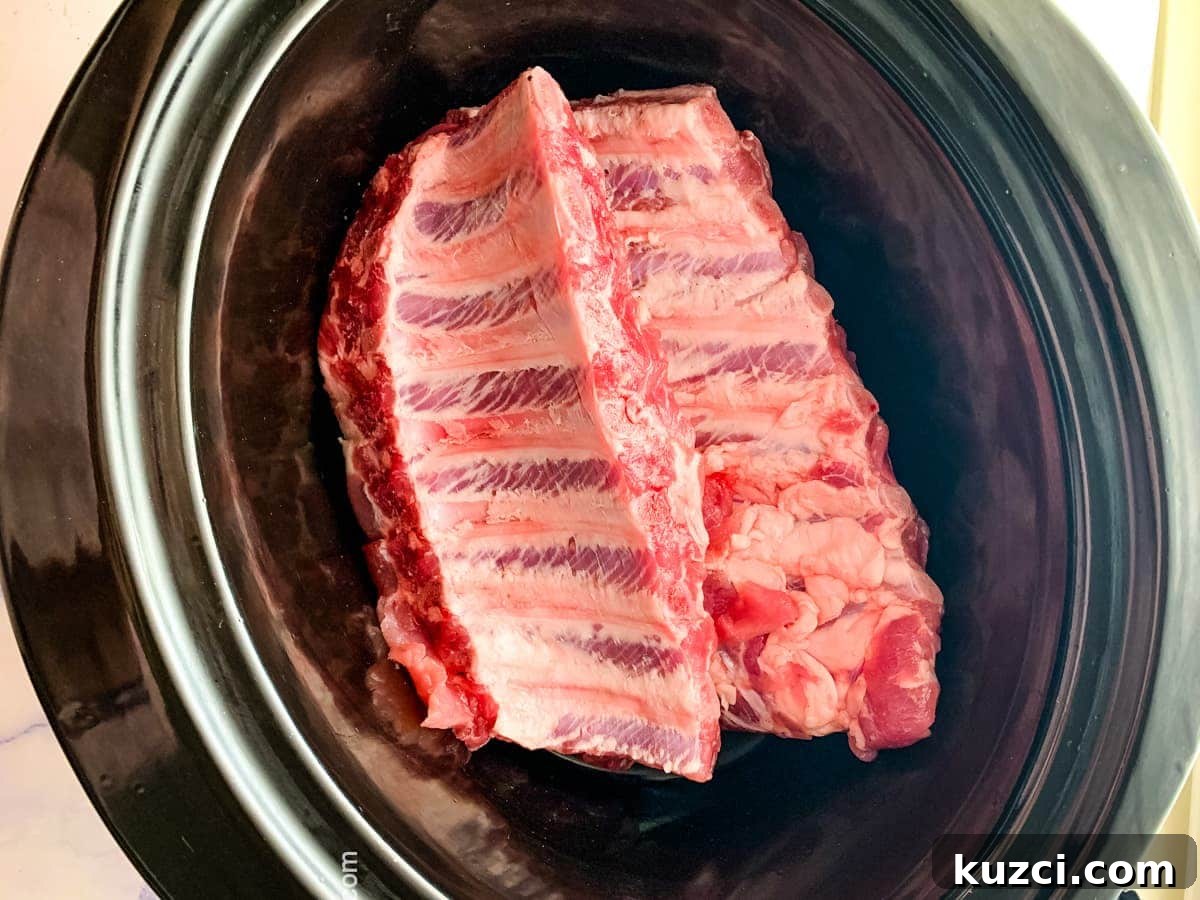 teriyaki ribs shown in the crock pot before basting with sauce