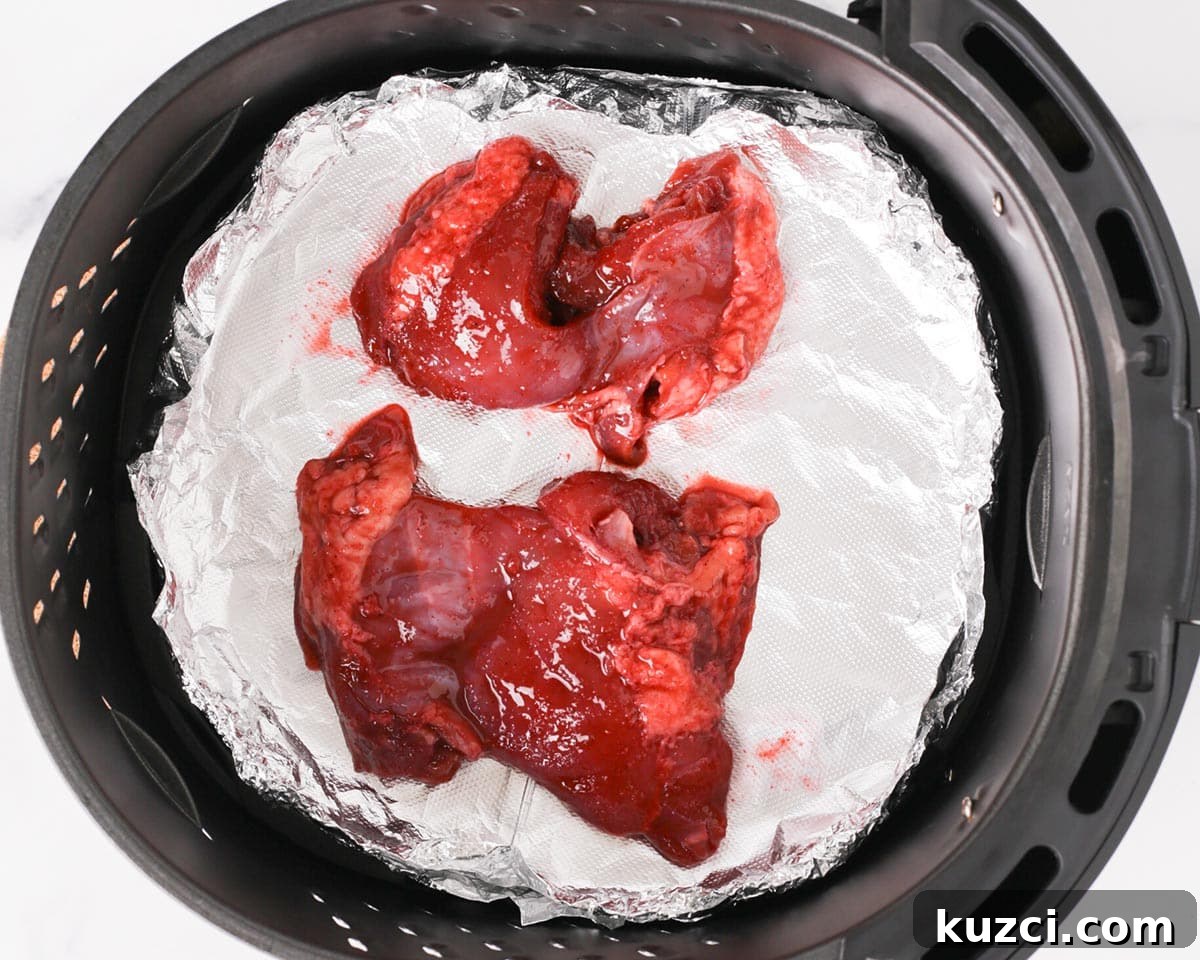 Sticky Char Siu Chicken: Cantonese BBQ Chicken Recipe 8 Placing the marinated chicken thighs in air fryer basket.