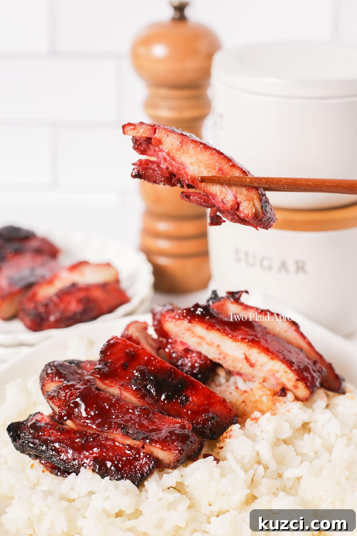 Sticky Char Siu Chicken: Cantonese BBQ Chicken Recipe 11 Holding a piece of char siu chicken.