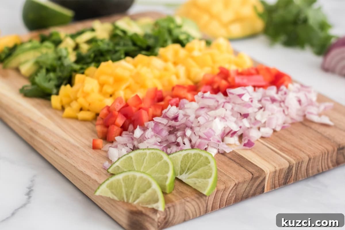 Fresh Mango Pico de Gallo Recipe 4 Ingredients to make pico de gallo chopped on a wooden cutting board.
