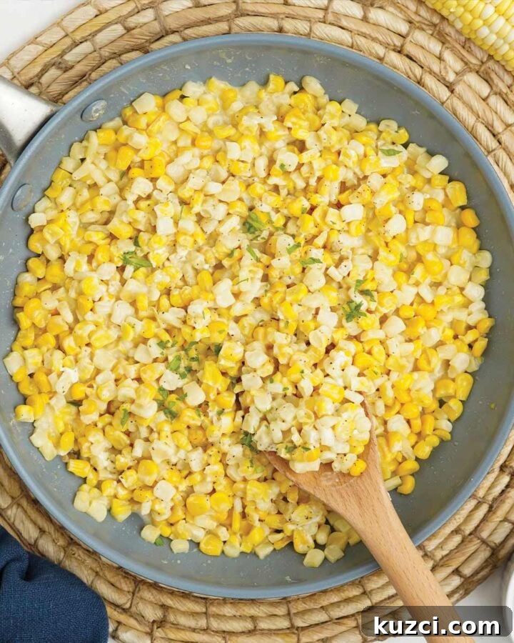 Skillet of honey butter corn with wooden spoon.