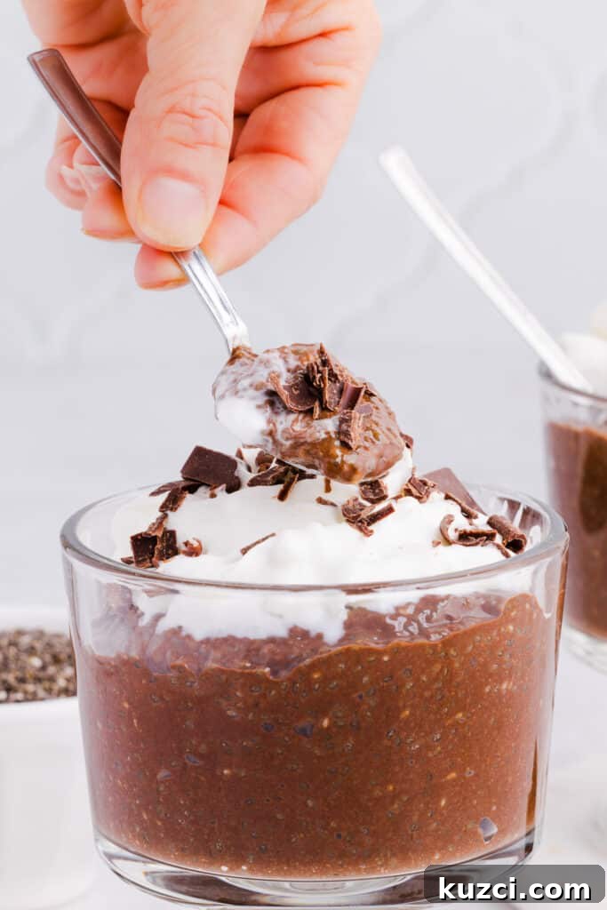 A spoon scooping out a spoonful of blended chia seed pudding.