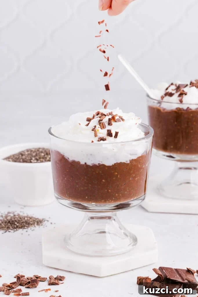 Chocolate shavings being sprinkled on top of blended chocolate chia seed pudding.