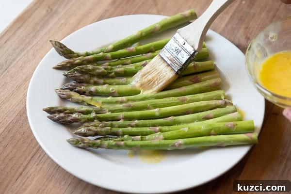 Crispy Air Fryer Asparagus Keto Recipe 5 Brushing Asparagus with beaten egg