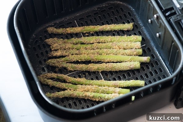 Crispy Air Fryer Asparagus Keto Recipe 7 Laying Asparagus in air fryer basket