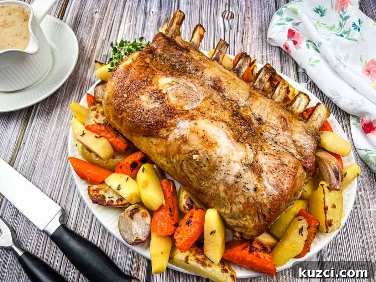 A plate of Pork Roast with Apples on a table.