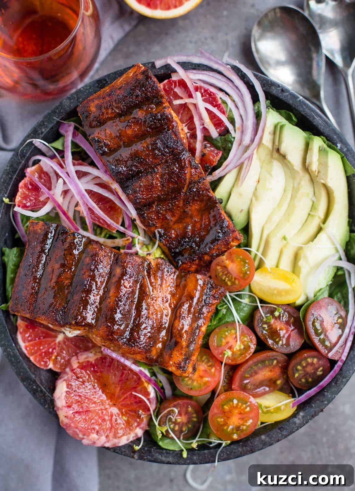 Grilled Salmon Salad Recipe with Citrus Vinaigrette 2 Grilled salmon salad in a bowl with a glass of rose wine