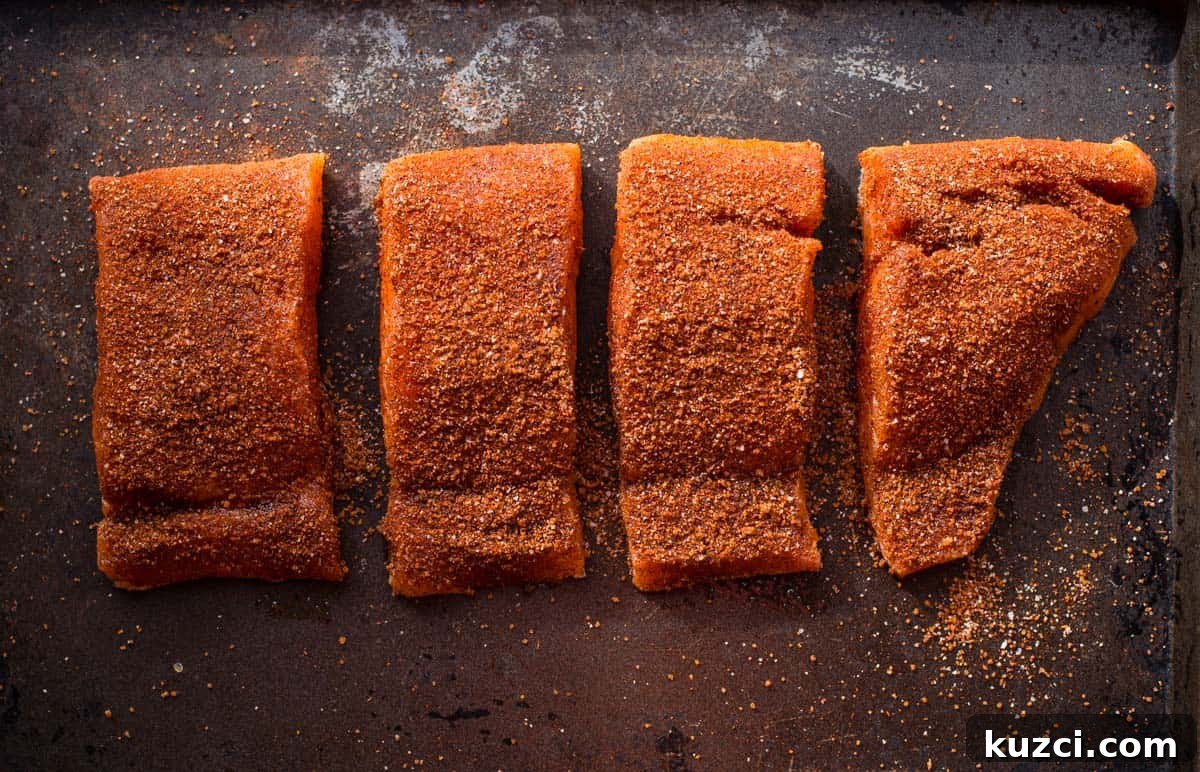 Grilled Salmon Salad Recipe with Citrus Vinaigrette 3 Raw salmon cut into pieces and covered with blackened seasoning