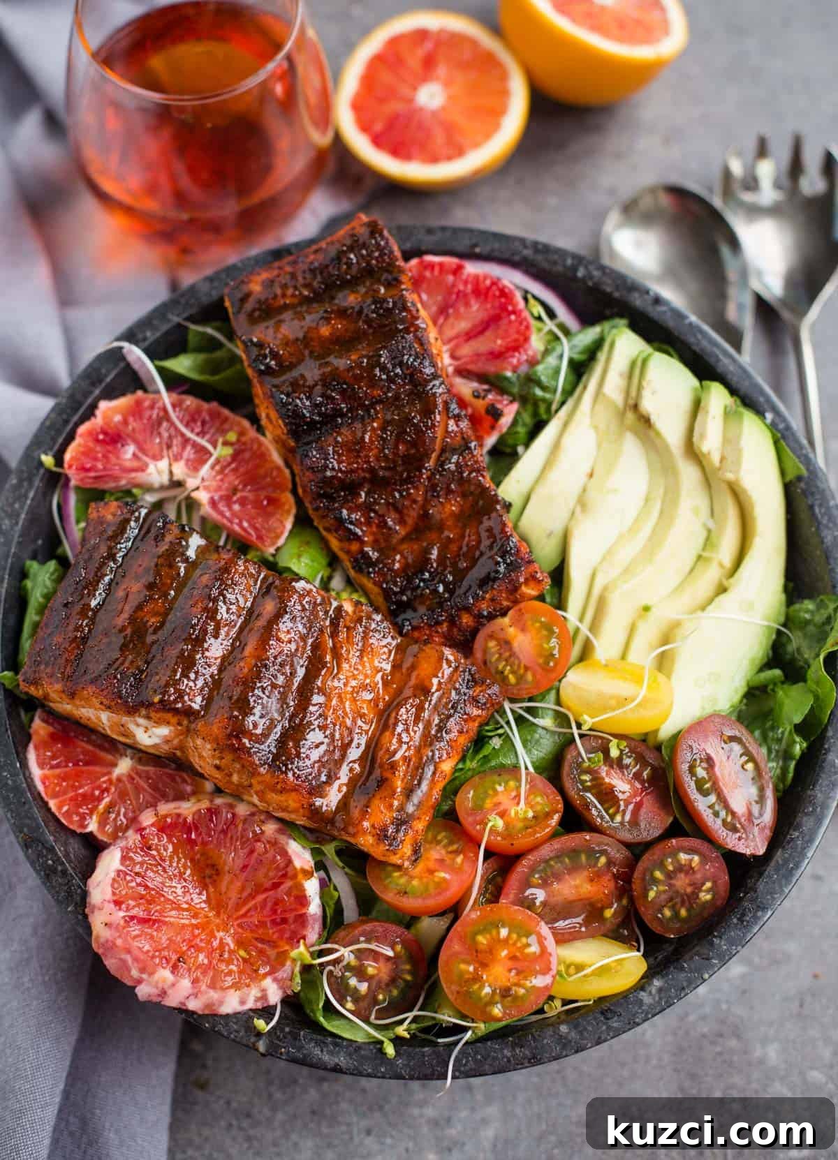 Grilled Salmon Salad Recipe with Citrus Vinaigrette 5 Grilled salmon salad in a bowl with avocado, tomatoes, and orange slices
