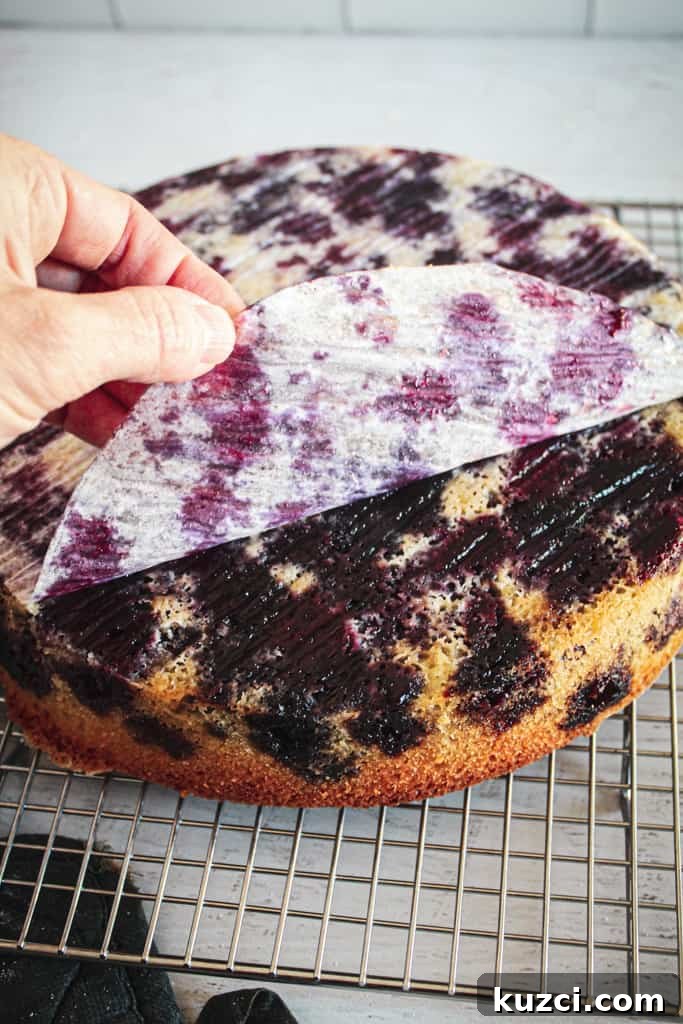 Moist Gluten Free Blueberry Cake Recipe 9 peeling parchment off baked blueberry cake