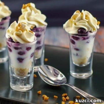 saskatoon berry dessert shooters on a black tray with a spoon
