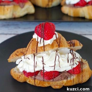 Strawberry eclair on a black plate