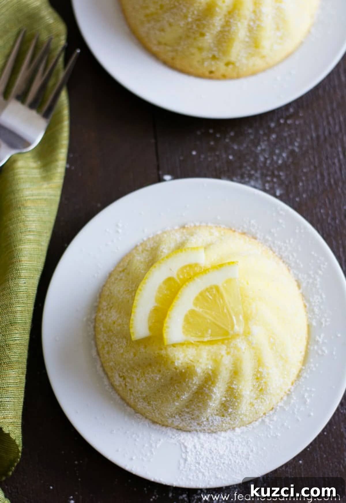 The top view of a lemon yogurt cake with sliced lemons on top.