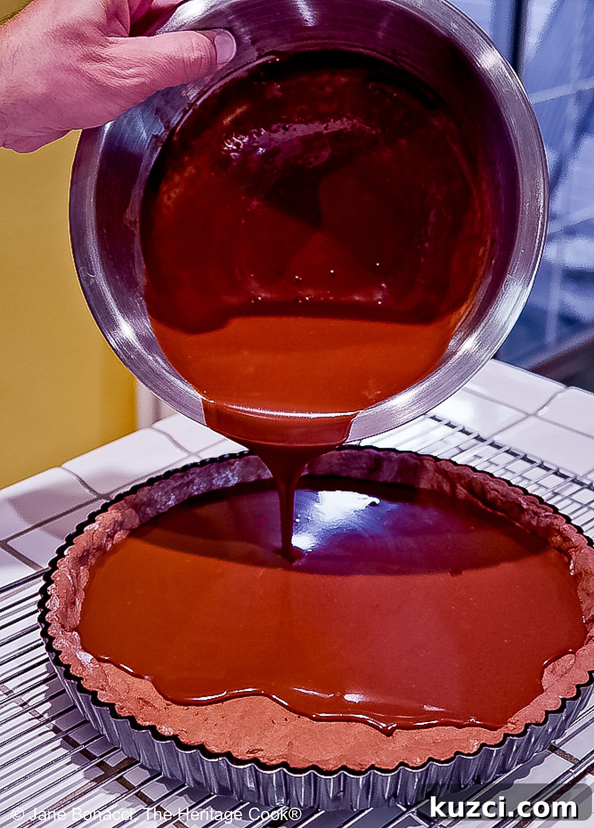Pouring the chocolate cream filling into the tart shell. 