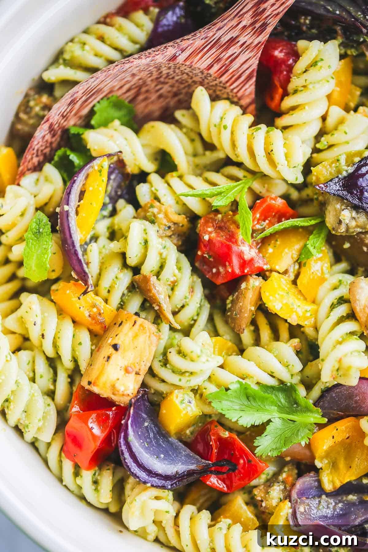 The colourful vegan pasta salad served in a large ceramic bowl