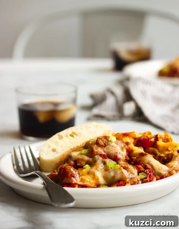 Ground beef casserole on a plate topped with green onions. 