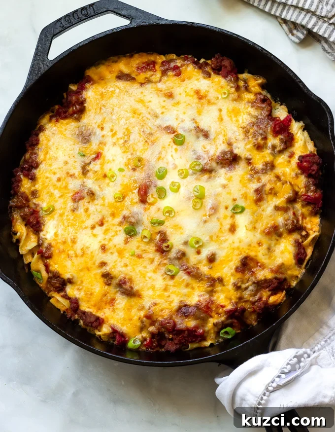 Ground beef egg noodle casserole topped with melted cheeses
