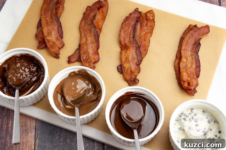 How to Make Chocolate-Covered Bacon at Home 3 chocolate melted in cups beside cooked strips of bacon