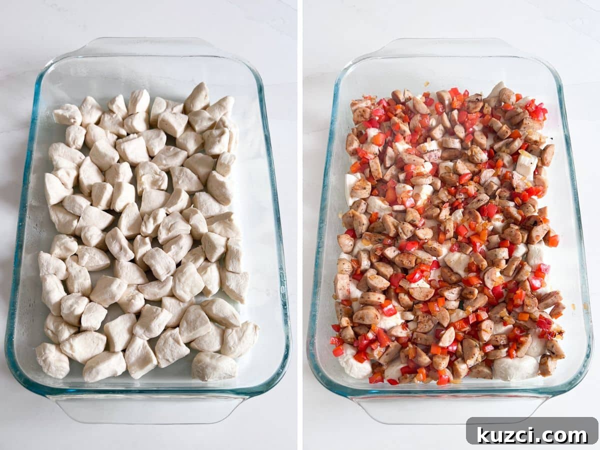 Raw biscuit pieces in a baking pan and then the sausage and veggie mixture added to it.