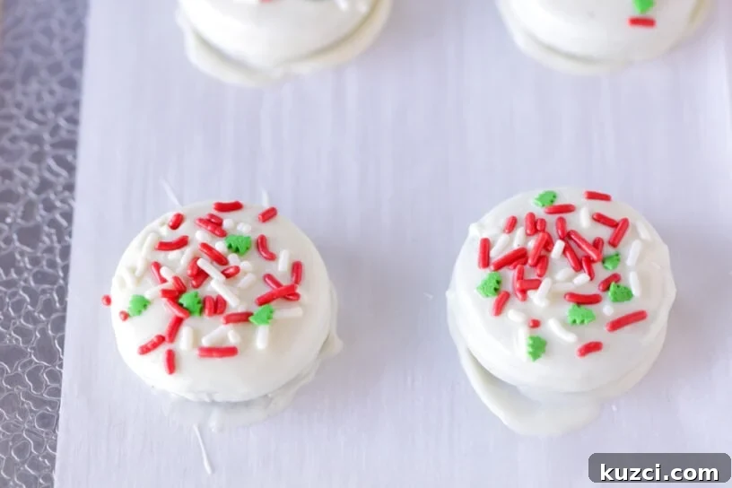 Christmas Oreos for Holiday Cookie Trays 4 White chocolate covered Oreos with sprinkles.