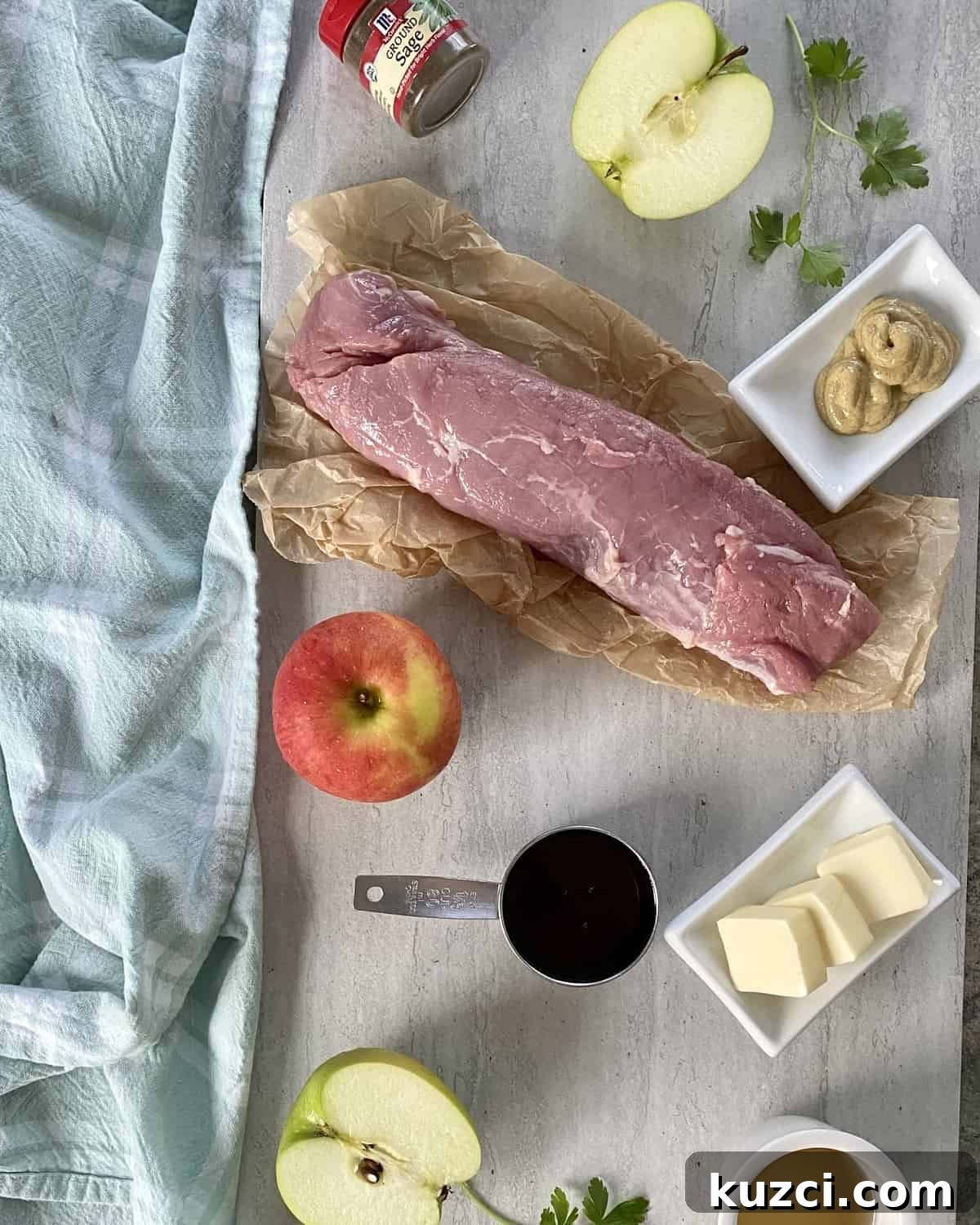 Maple Glazed Pork Tenderloin with Apples 3 A pork tenderloin, apples, maple syrup, butter, mustard and ground sage on a marble counter.