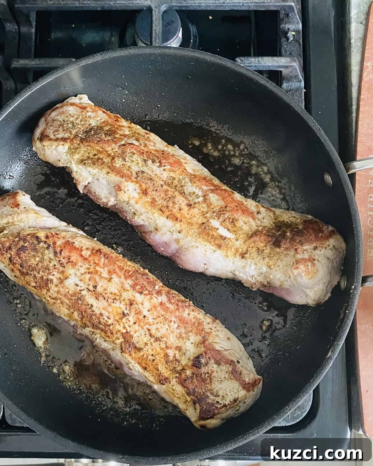 Maple Glazed Pork Tenderloin with Apples 4 Searing two pork tenderloins in a cast iron skillet.