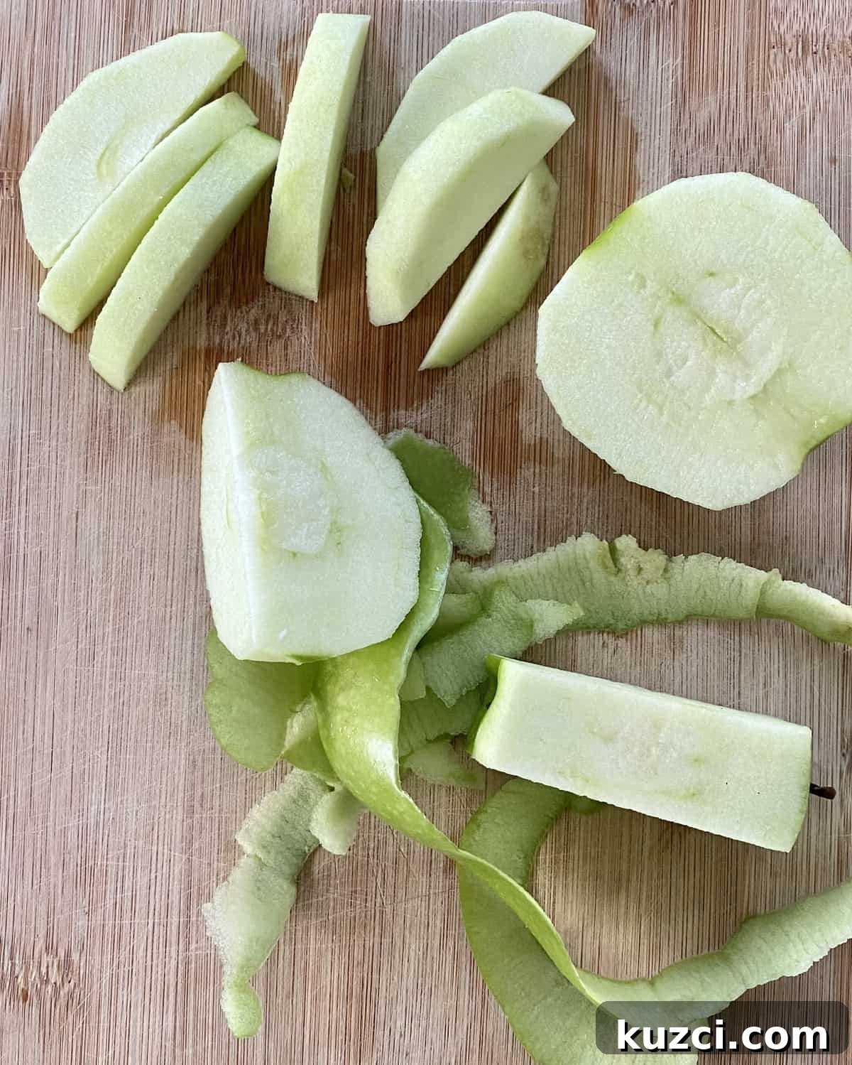 Maple Glazed Pork Tenderloin with Apples 5 A peeled and sliced Granny Smith apple on a cutting board.