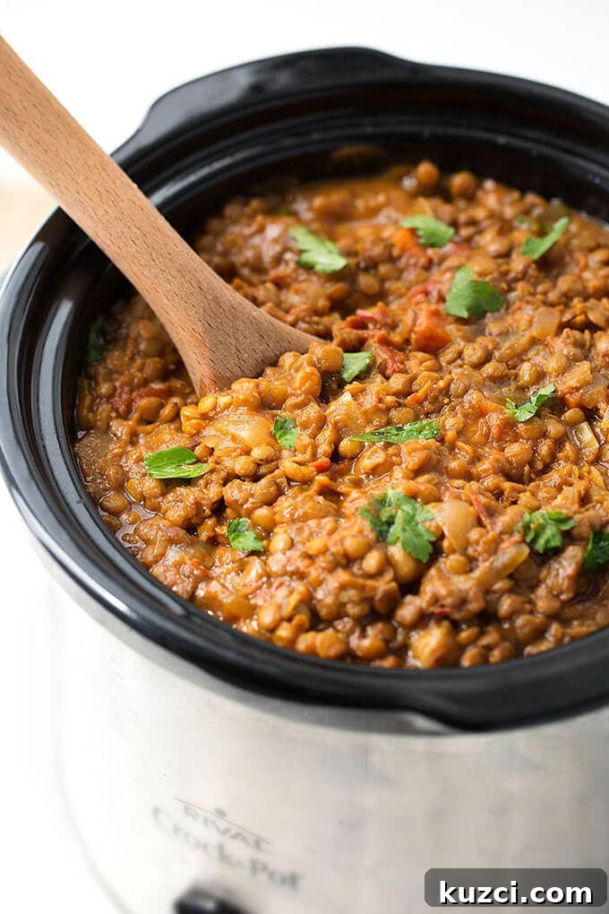 Slow Cooker Curried Lentils 2 Crock Pot Curry Lentils in a crock pot with wooden serving spoon