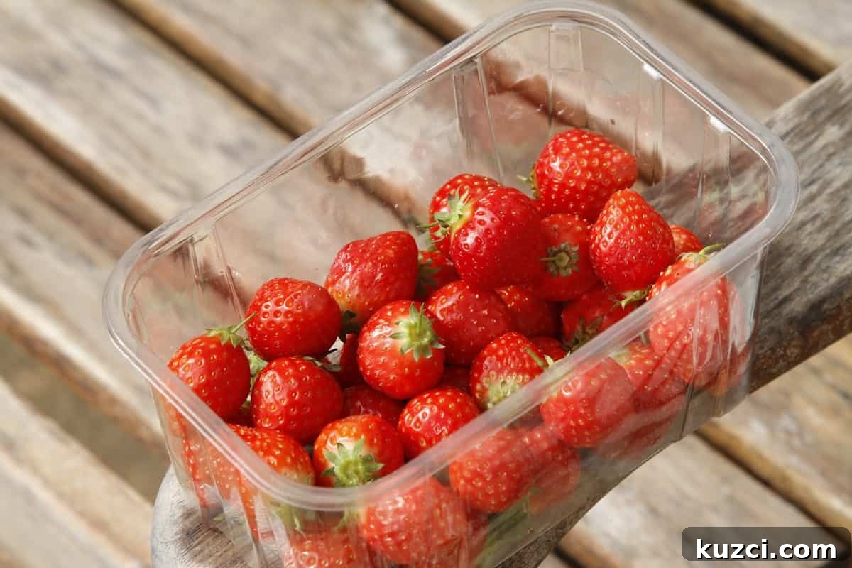 Fresh strawberries in a plastic container.