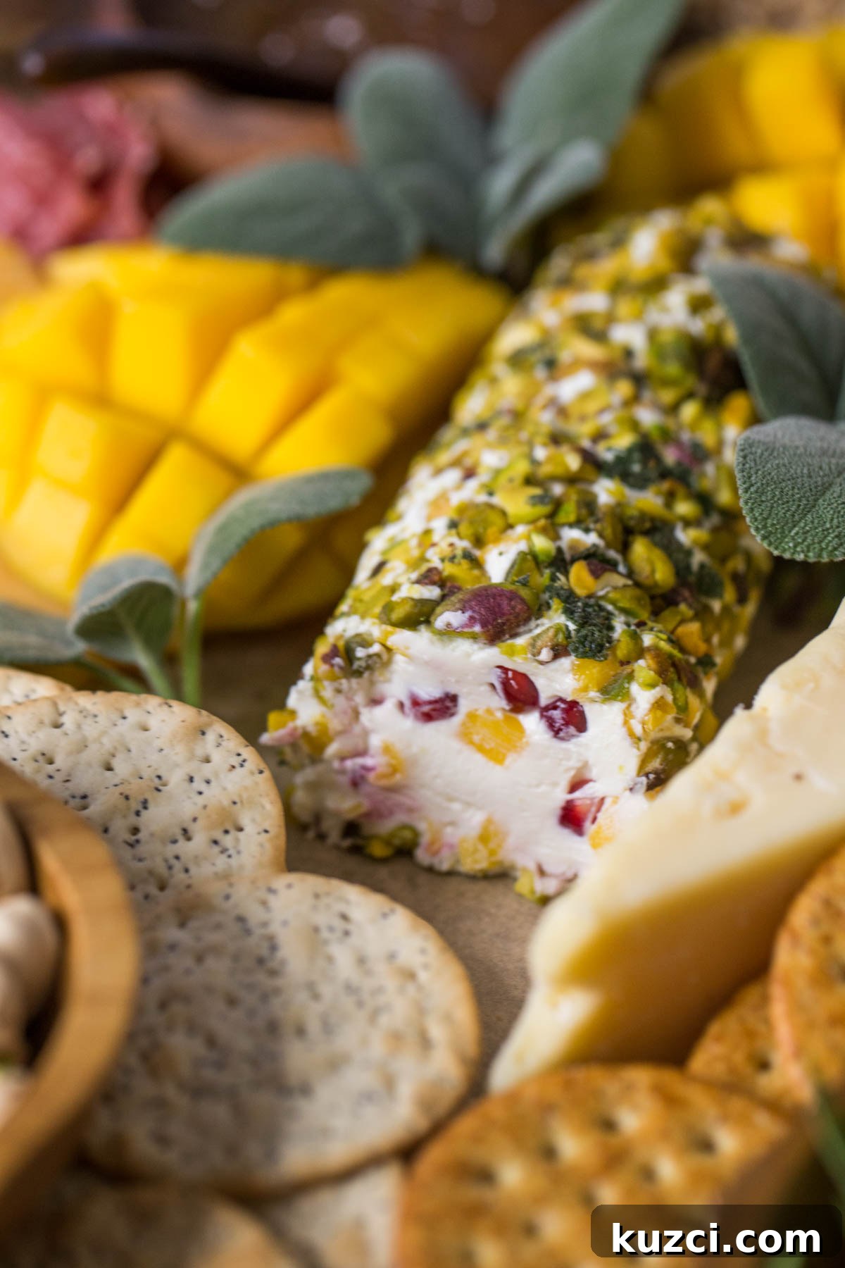 Mango Cheese Log with Pistachio Crust 2 Close up view of Pistachio Crusted Cheese Log displayed as part of a charcuterie.