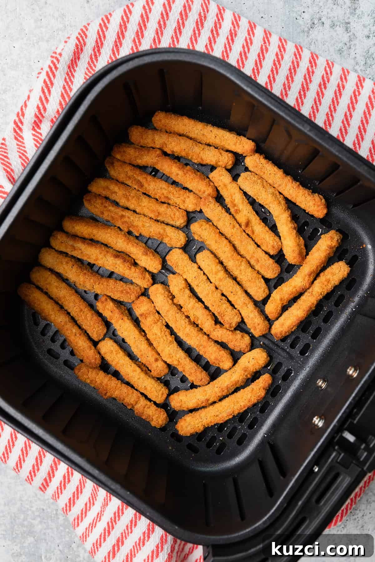 Cooked chicken fries in the air fry basket.