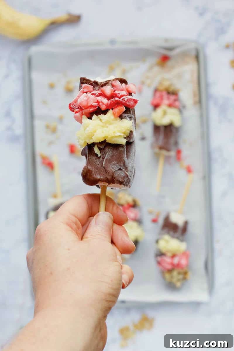 Frozen Banana Split Pops with 6 Ingredients 2 Hand holding Frozen Banana Split Pop
