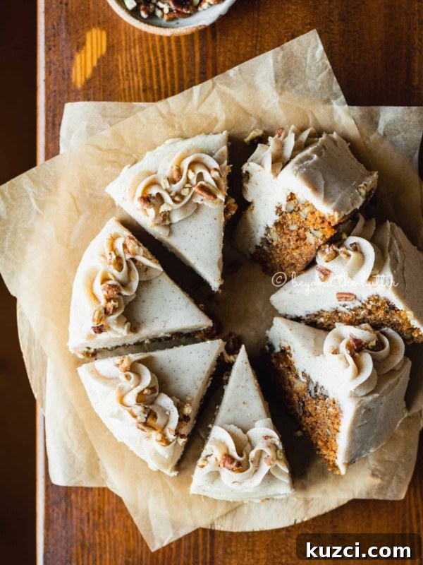 Moist Single Layer Coconut Cake Recipe 7 Overhead image of single layer carrot cake frosted on parchment paper and placed on a wood dining room table.