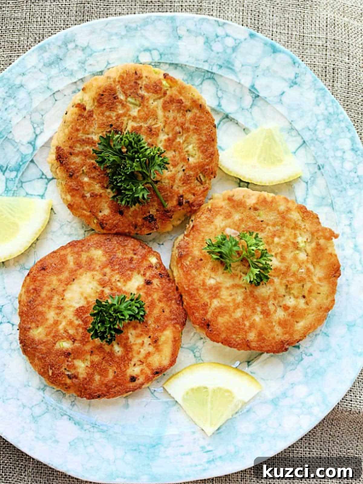Mom's Homemade Salmon Patties Recipe 2 three plated salmon patties garnished with fresh parsley