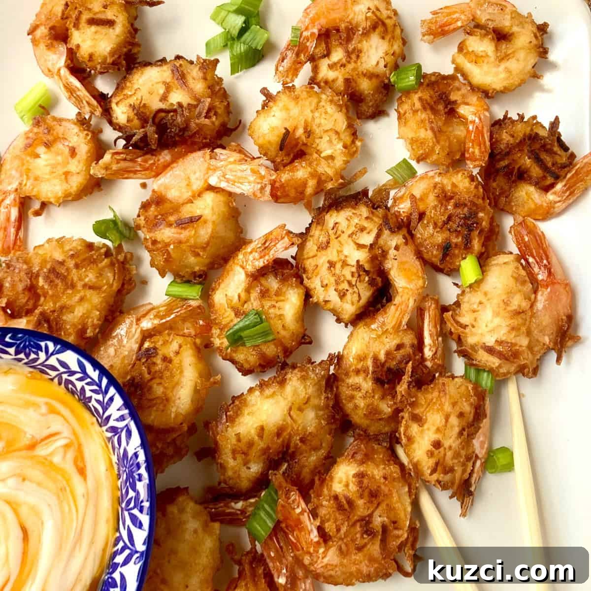 Crispy fried coconut shrimp garnished with green onion.